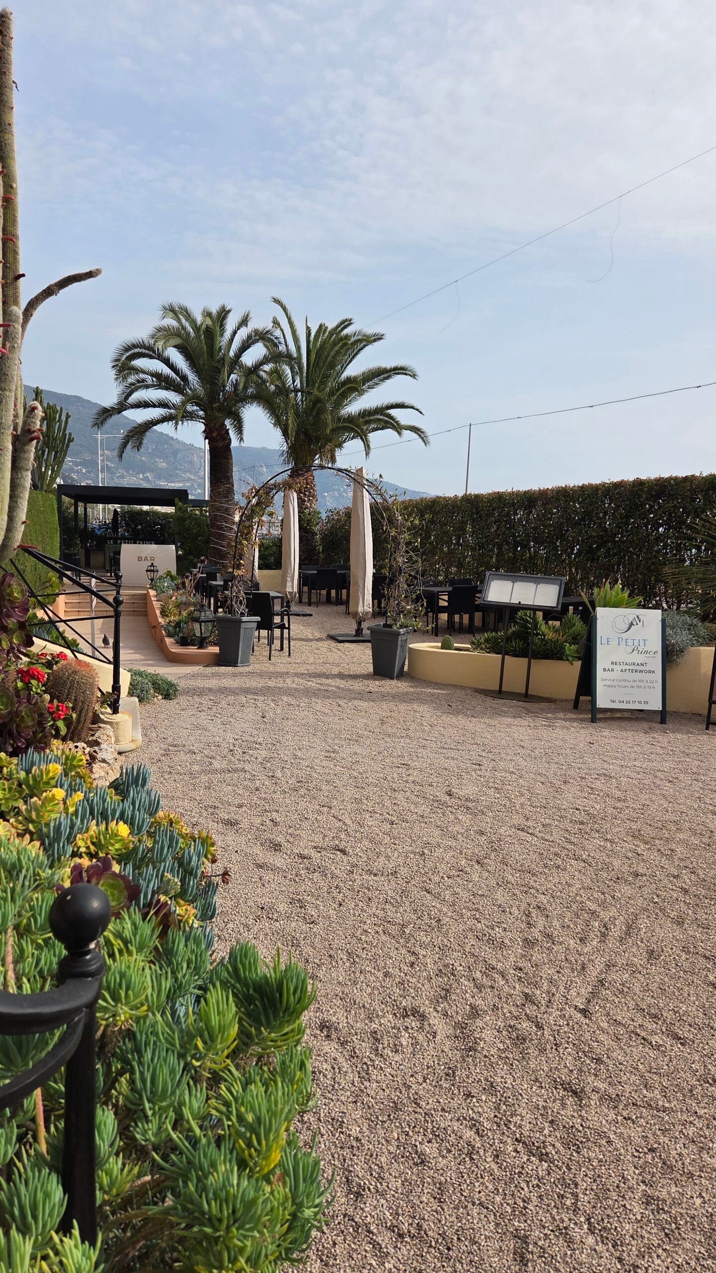 Exotic garden and terrace bar at Best Western Premier Hotel Prince de Galles, Menton, with palm trees and Mediterranean plants