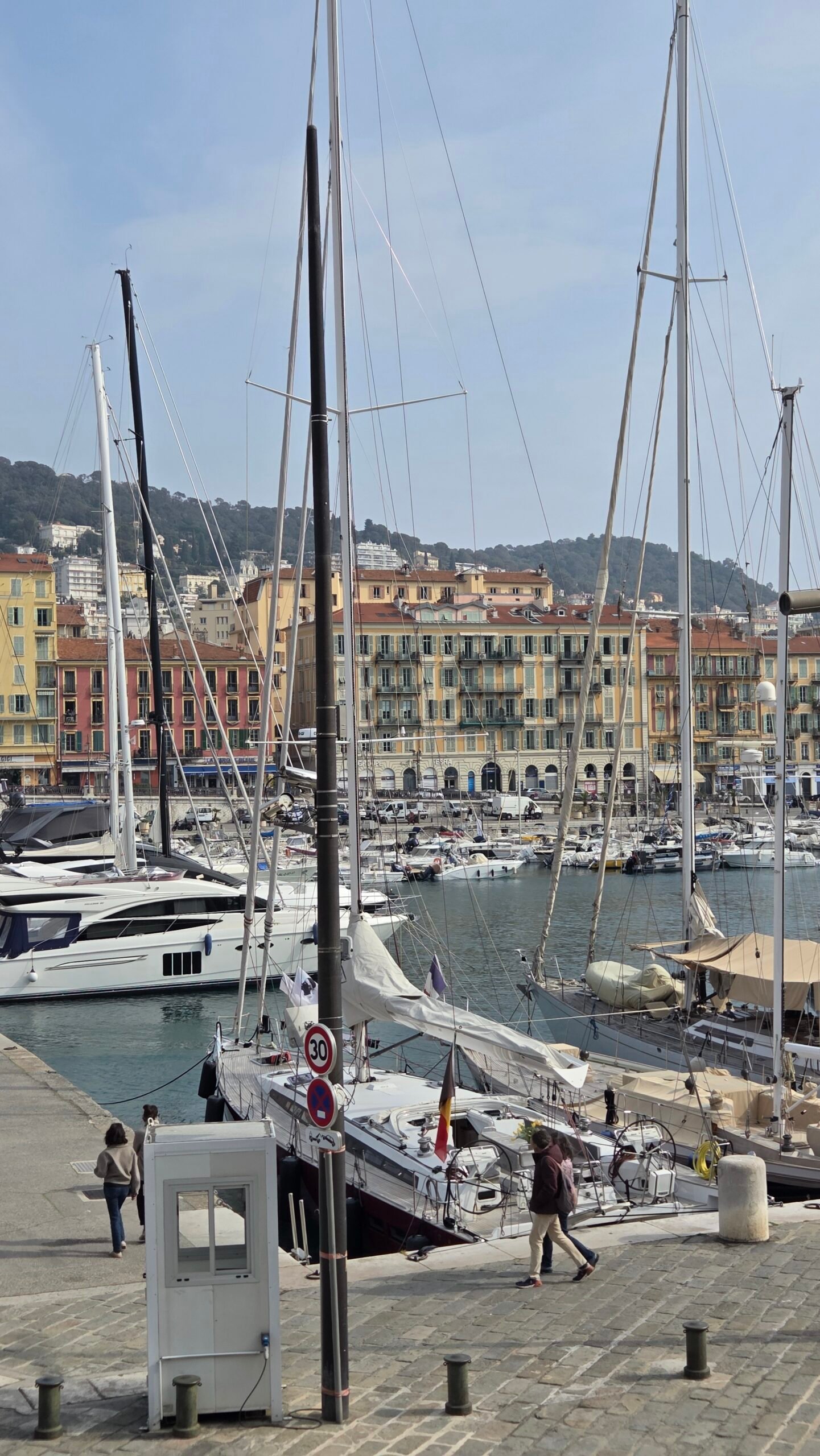 Yachts and colorful buildings in Nice Port, a short walk from Hotel Suisse