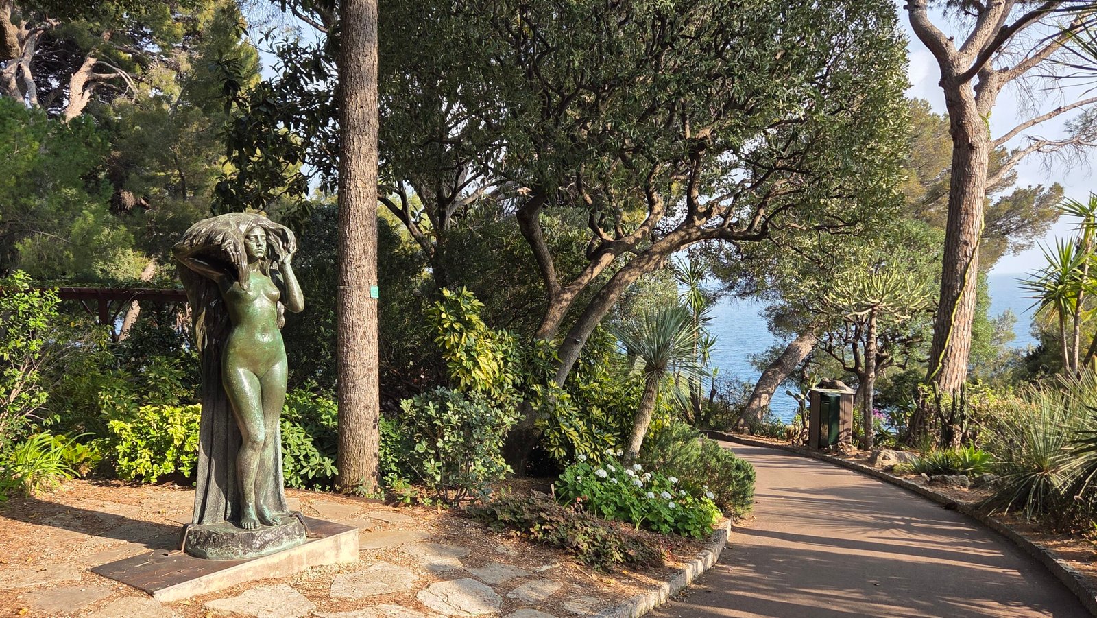 Bronze statue of a woman among trees in the Jardins Saint-Martin, Monaco