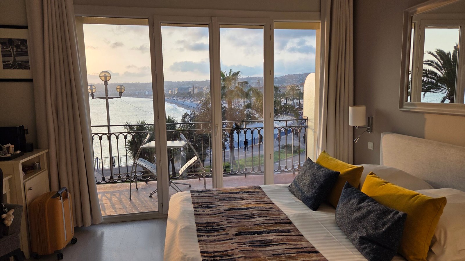 Superior room at Hotel Suisse Nice with a bed facing sea-view balcony doors