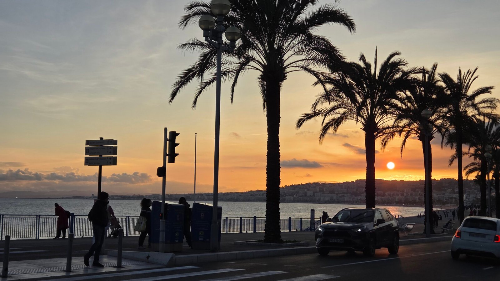 Sunset behind palm trees on the Promenade des Anglais in Nice