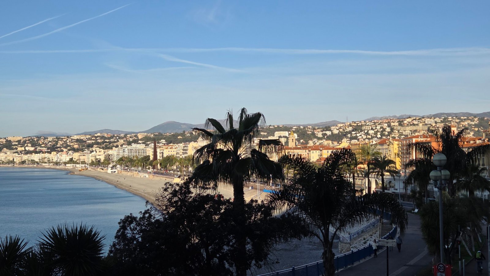 Morning view of Nice's beach and old town under a blue sky from Hotel Suisse Nice