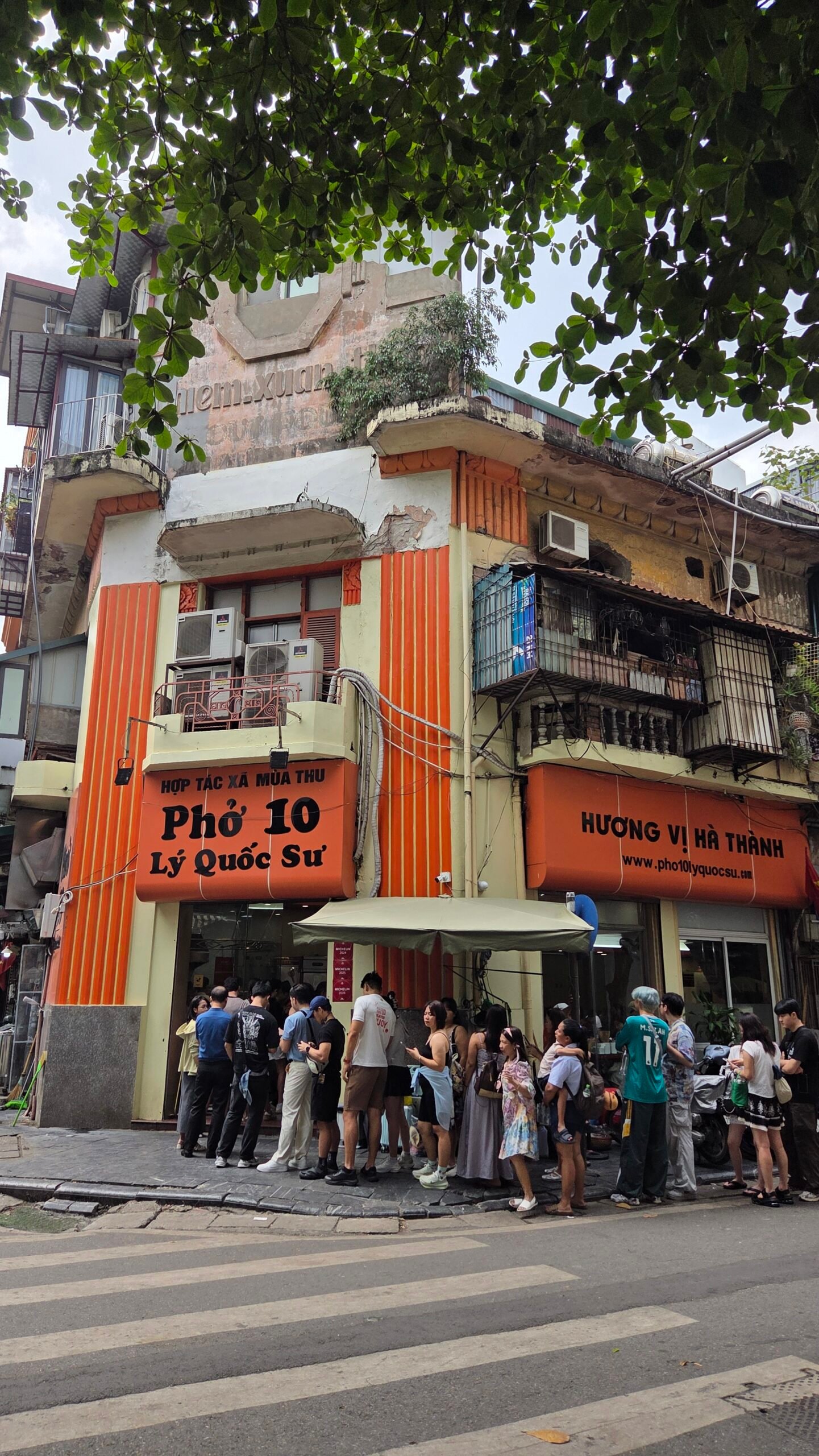 Phở 10 Lý Quốc Sư's storefront, one of three Hanoi Michelin restaurants in this guide, with a queue out front