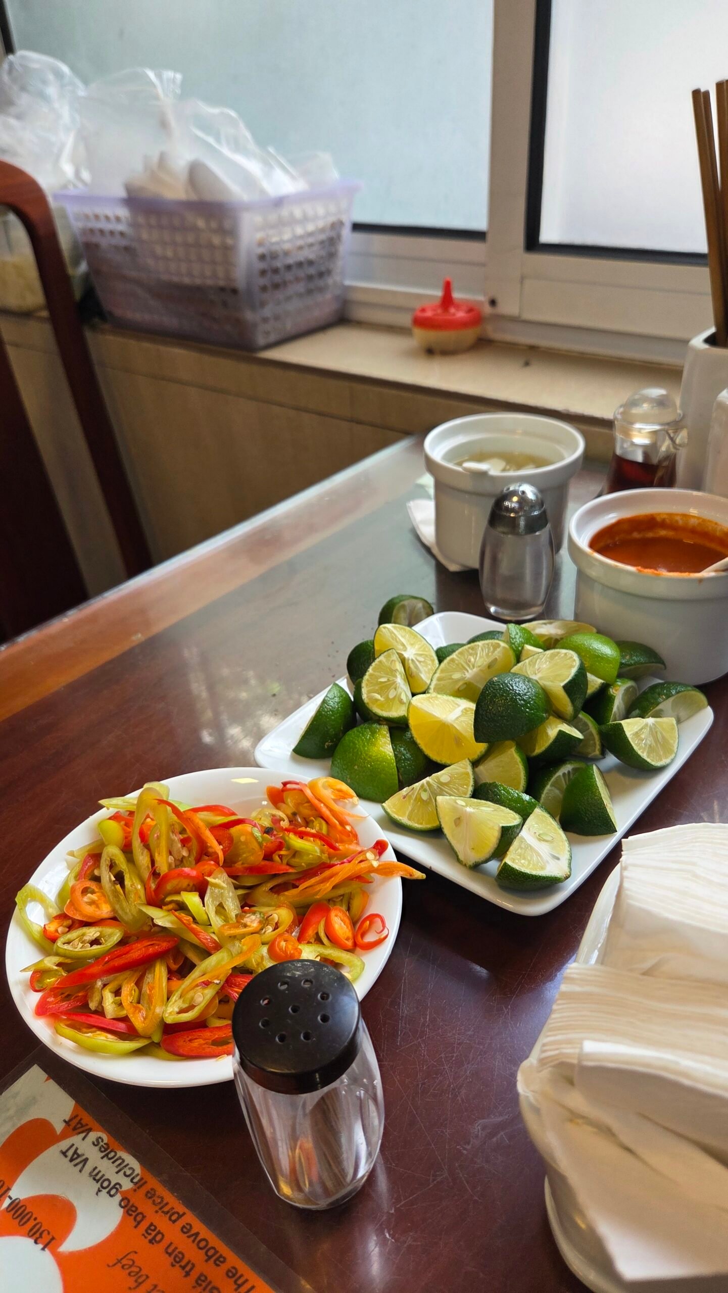 The pile of limes and chilies on the table, with fried dough sticks