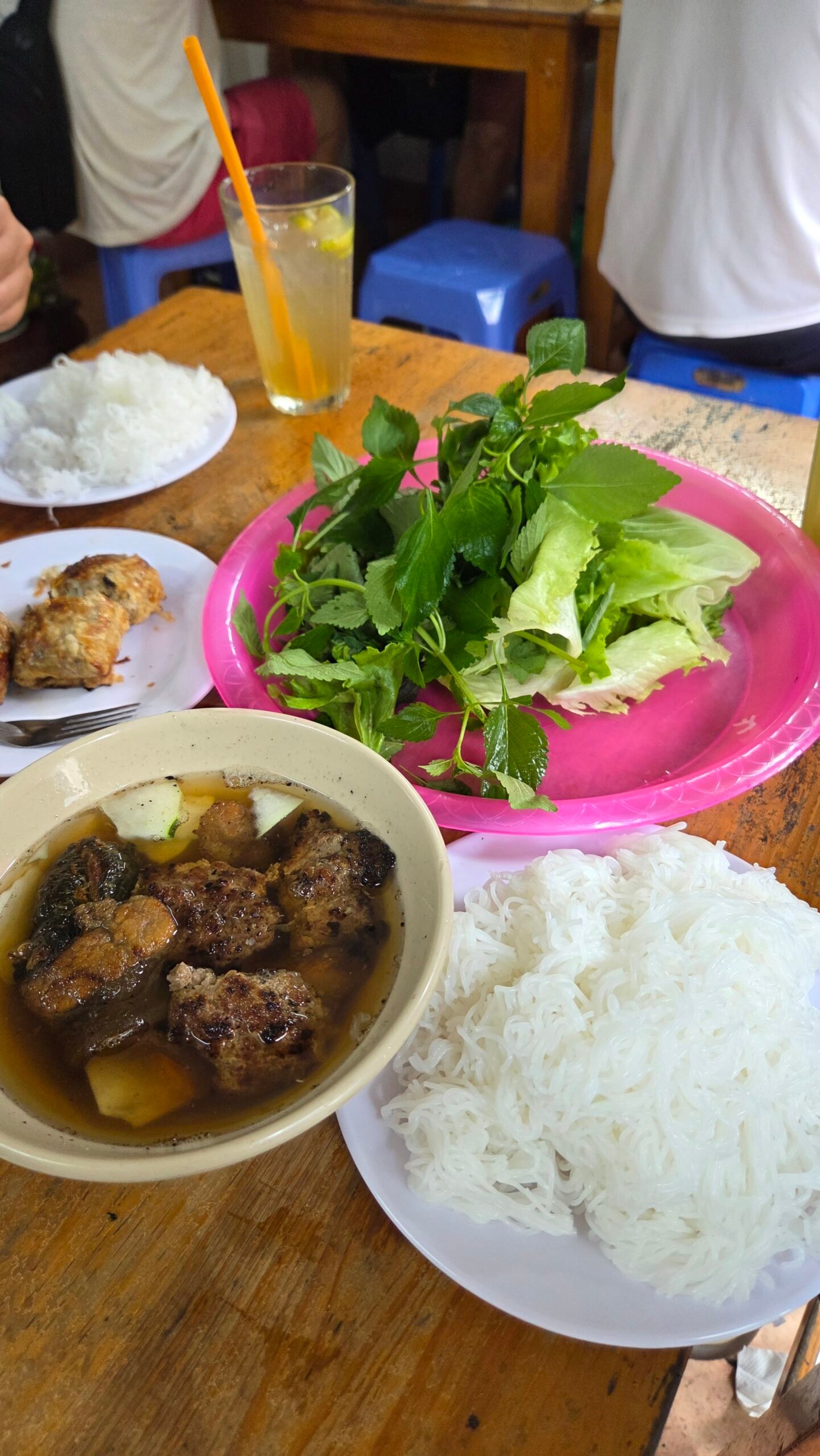 The full spread — bún chả, rice noodles, and herbs