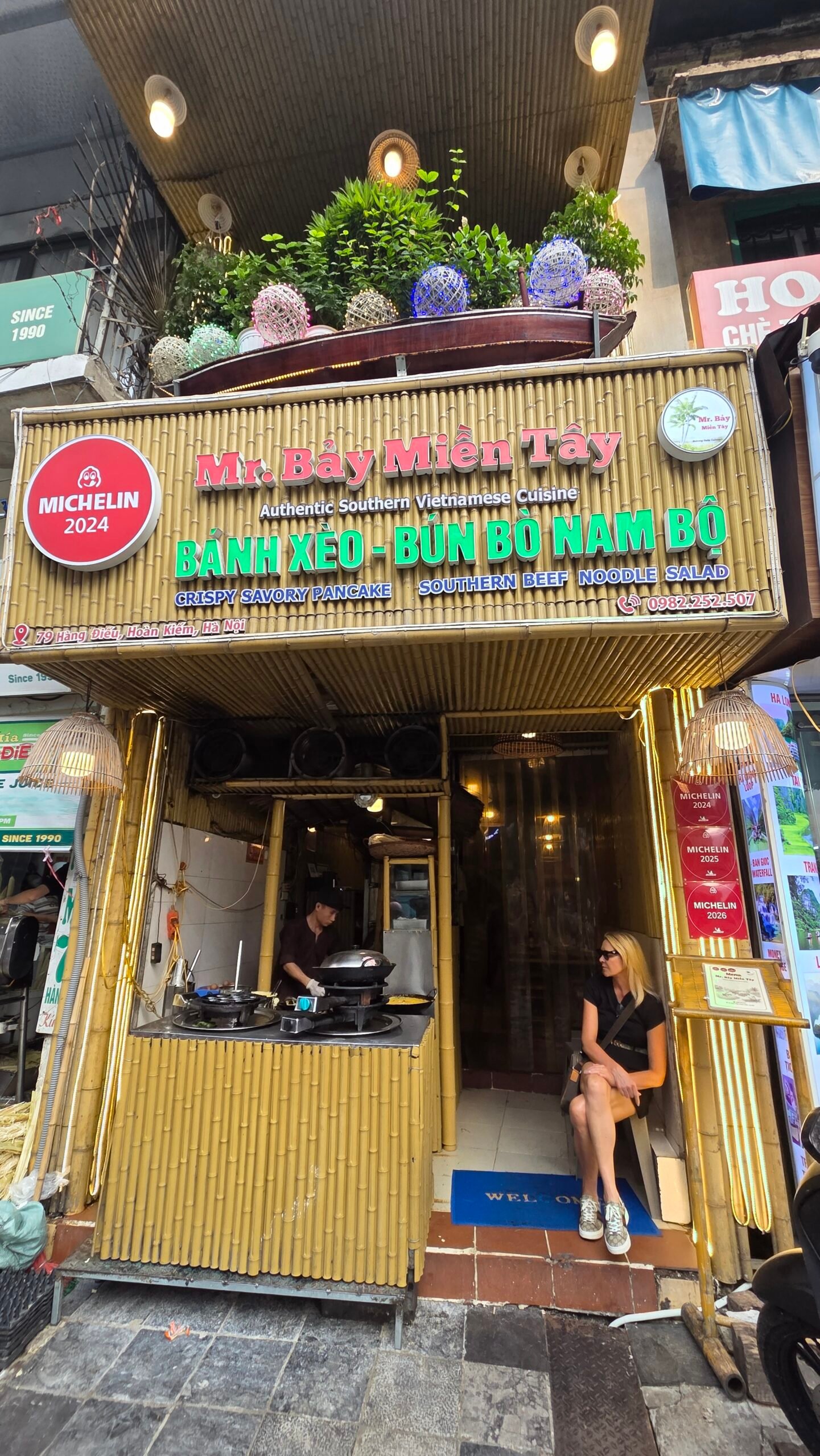 Mr Bảy Miền Tây's storefront, with Michelin medallions on the sign
