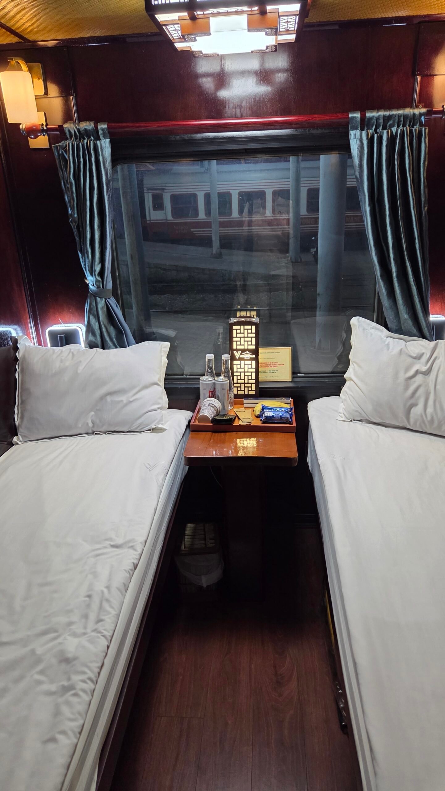 Private 2-berth cabin on the Hanoi to Sapa sleeper train, both beds and the view out the window
