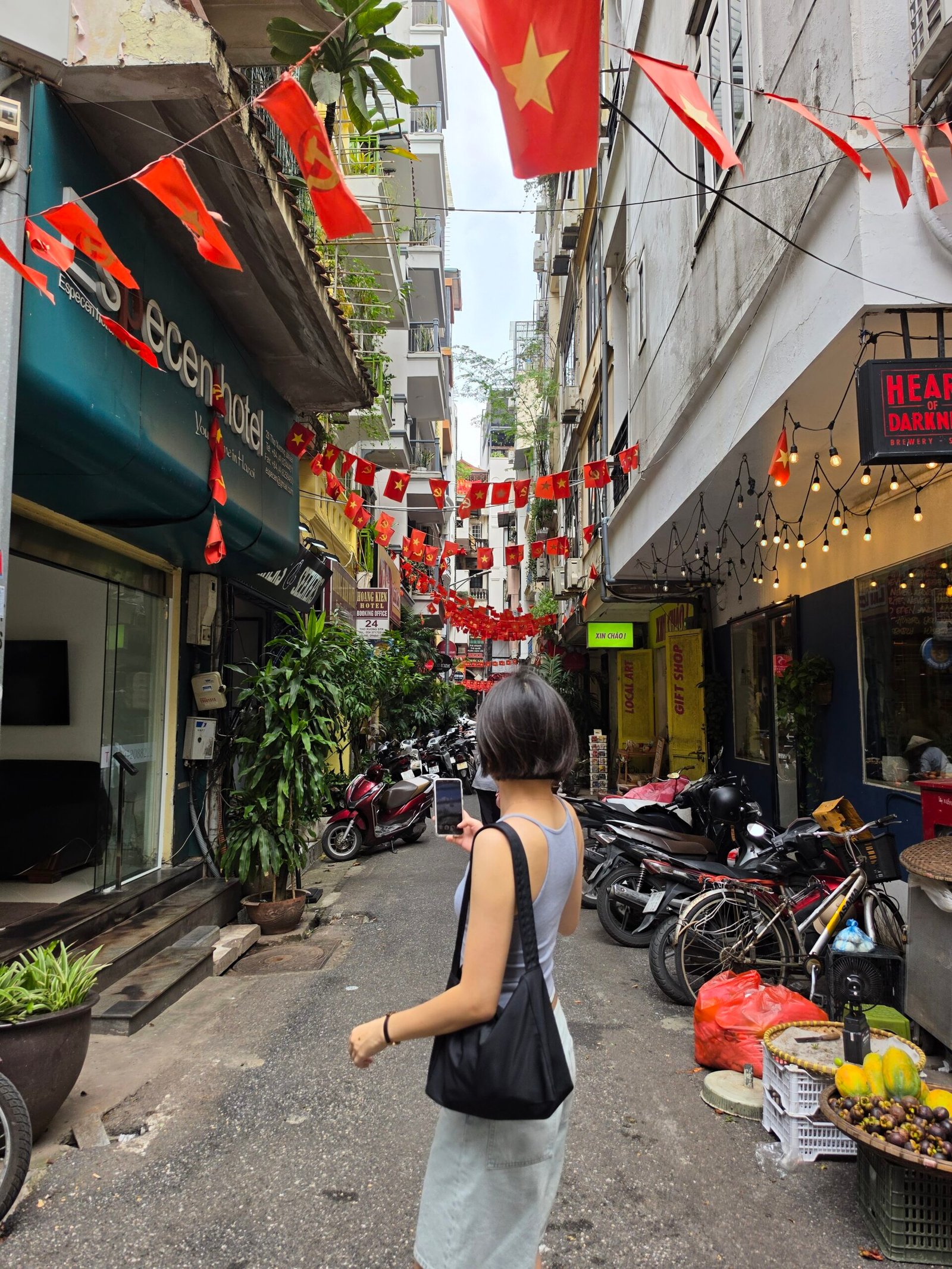 A Hanoi Old Quarter alley strung with red flags